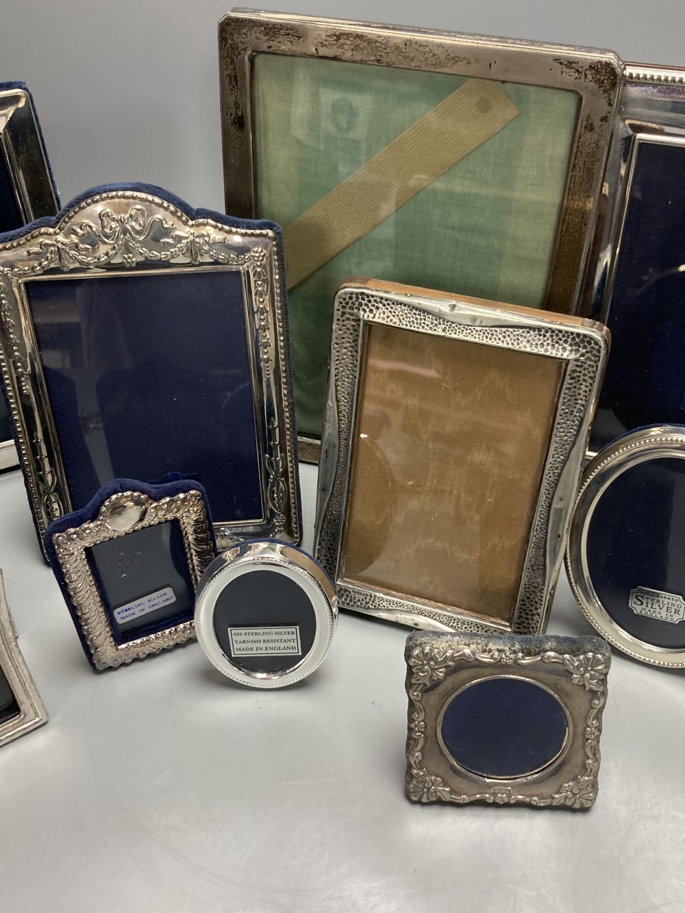 Two George V silver mounted photograph frames, largest 21cm, nine other modern silver frames and two cased silver crowns etc.